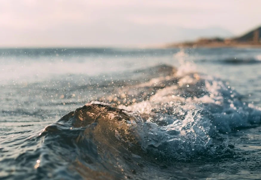 Peaceful sea view with gentle waves and golden sunlight